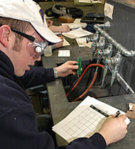Student experimenting in chemistry lab.