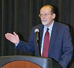 Dr. Hallwas lecturing from podium.