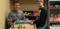 Male teacher and young boy playing a game