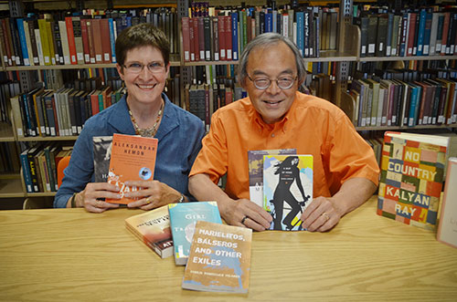 Picture of Felix and Nancy Chu sitting at a table holding books