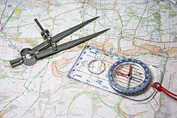 Photo of a map with a compass on top of it.