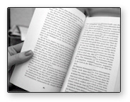 image of a hand holding a book with no bookmark