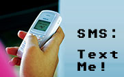 Image of a person texting on their cell phone with the text SMS: Text Me!