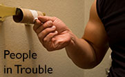 Photo of a person in the bath room reaching for the toilet paper which has run out and the text People in Trouble.