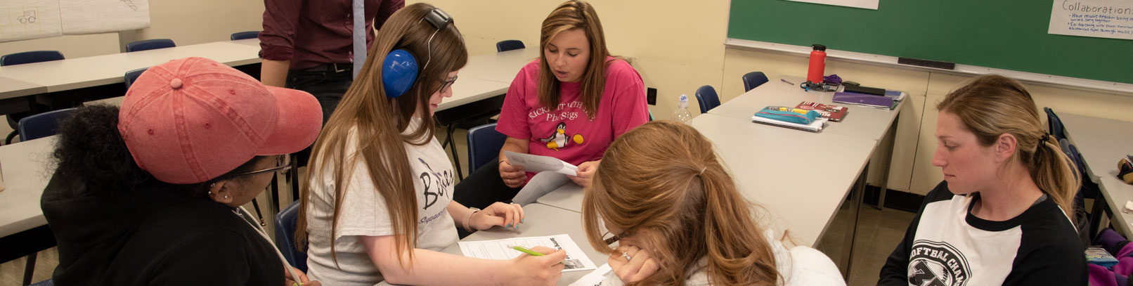 Special Ed program undergraduate students working with a student.