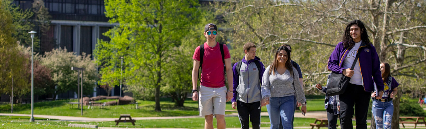 Photo of a group of students walking down a sidewalk.