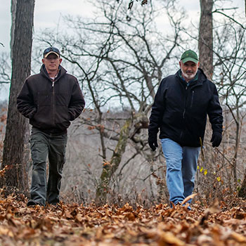 Sean Jenkins and Neil Gillespie walking through the woods