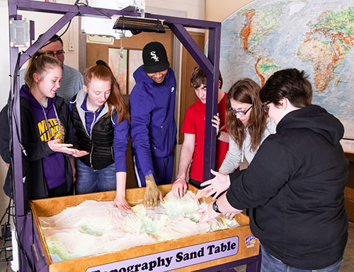 student working with typography sand table
