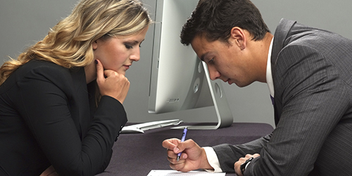 Two people looking at a document