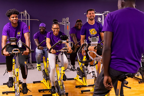 students working out on stationary bicycles