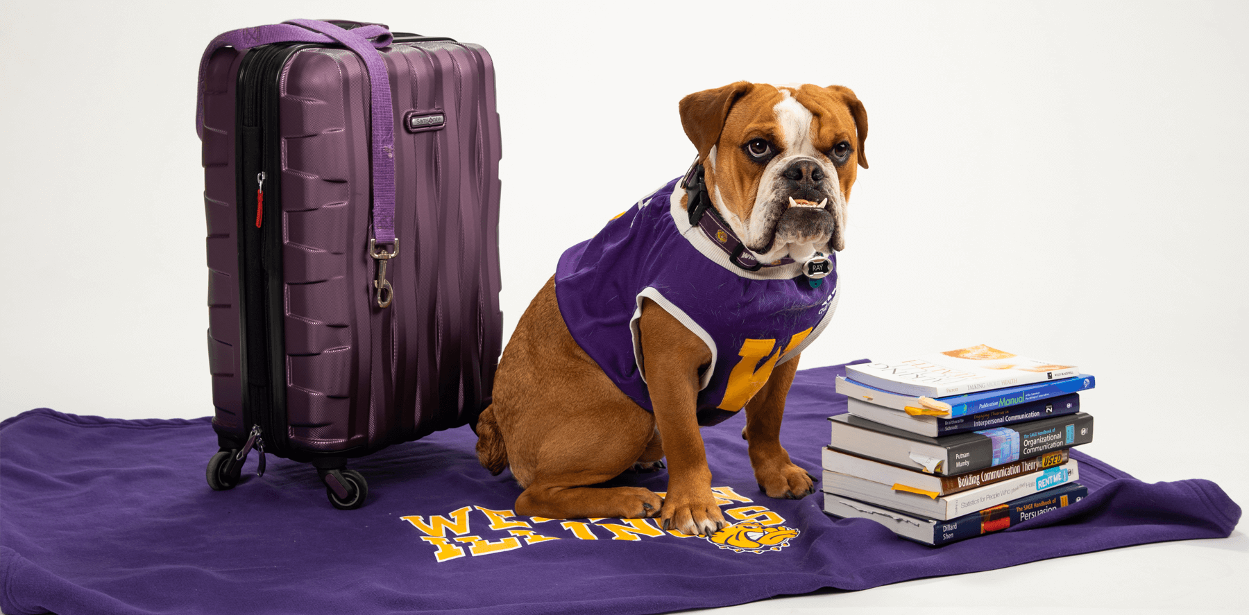 New First Year Student Registration - Ray "Colonel Rock IV" with books and a suitcase