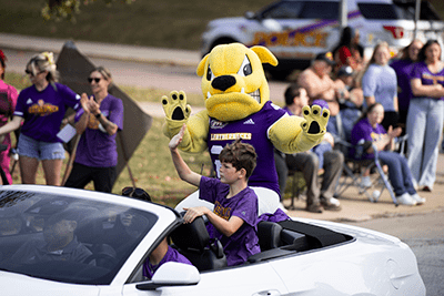 Costume Rocky Mascot in convertable car
