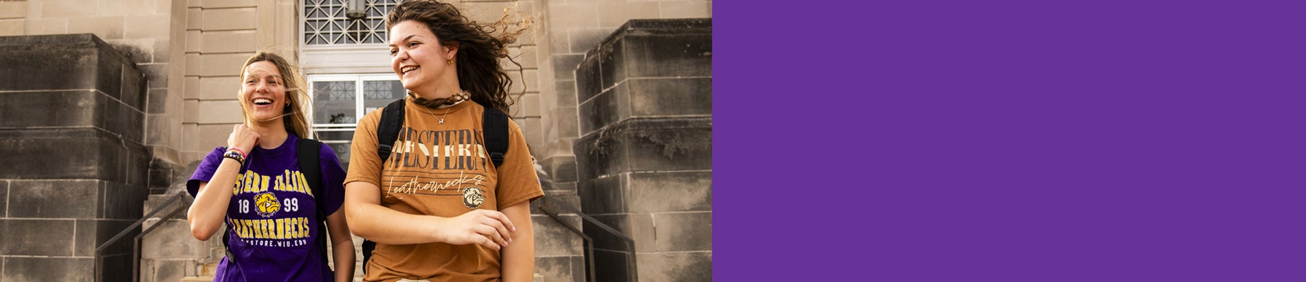 students wearning Western Illinois University shirts standing in front of Garwood Hall