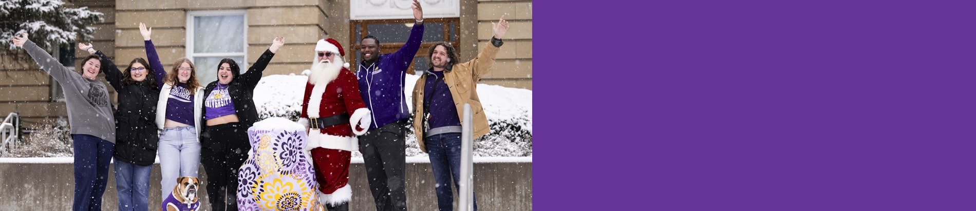 students with Santa Claus and Col. Rock IV in front of Sherman Hall waving