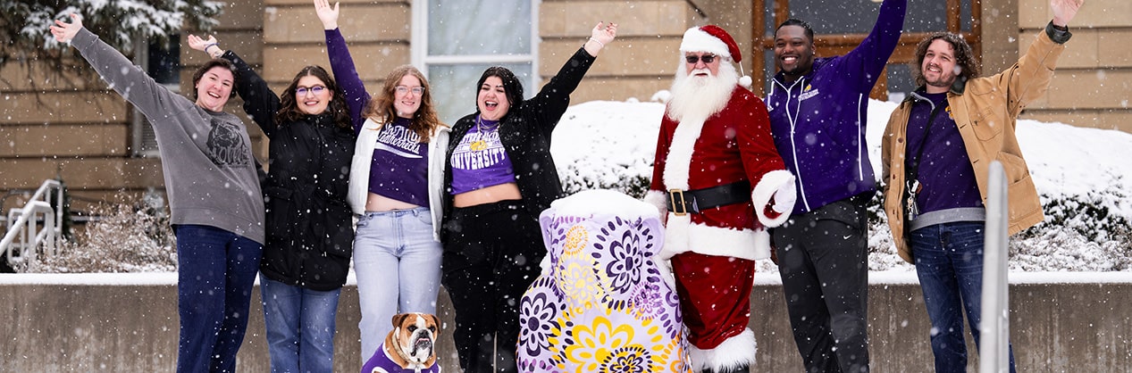 students with Santa Claus and Col. Rock IV in front of Sherman Hall waving