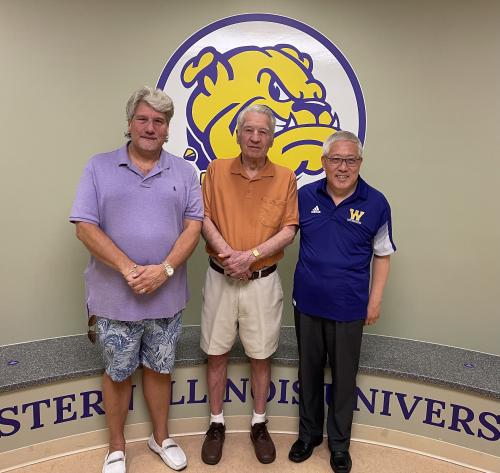 A.J. ''Jan'' Ryden (center) stands with son, Eric Ryden and WIU President Guiyou Huang.