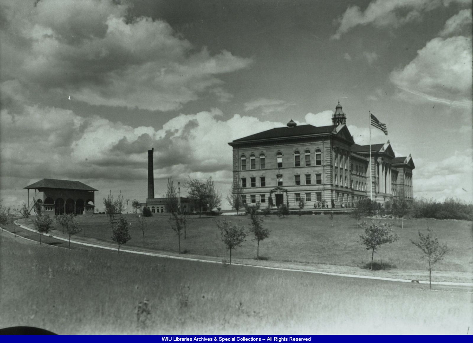 Sherman Hall, the campus powerhouse and the 1905 football grandstand on the Western Illinois State Normal School campus, circa 1906.