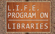 A wooden plaque on a cement wall with the text L.I.F.E. PROGRAM ON LIBRARIES