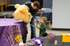 Man shows the costume head of WIU's Mascot Rocky to boy.