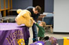 Boy touches the costume head of WIU's Mascot Rocky.