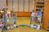 A mini-golf hole with bookshelves on either side with books on display.