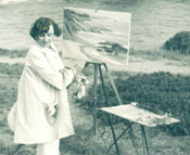 A photo of Joane Cromwell painting along the California coast, with her dog Caesar, circa 1940.