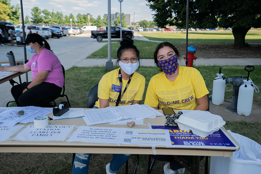 Photo of three move in crew members at a table