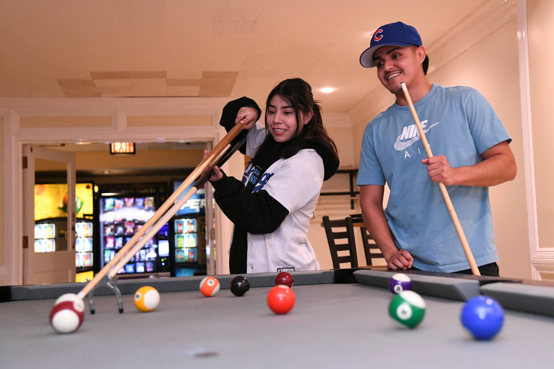 Two people playing a game of pool