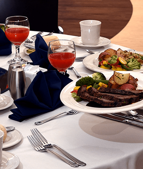 Photo of table setting with a dinner plate and wine glasses