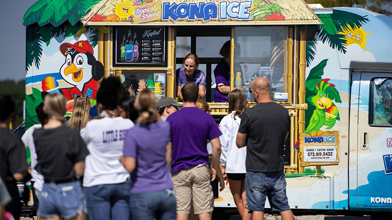 people in line at a snow cone food truck