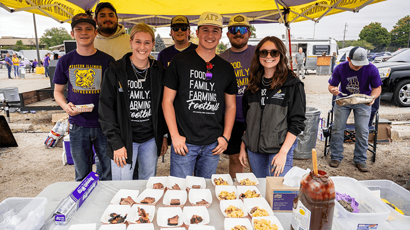 group of people in a tent displaying their bbq