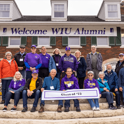 People in front of the Alumni House