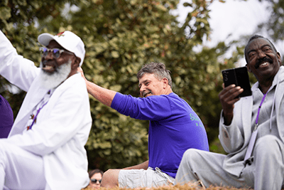 Three guys on a parade float waiving